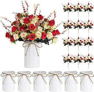 Rustic spring centerpiece with red and cream roses in a farmhouse vase
