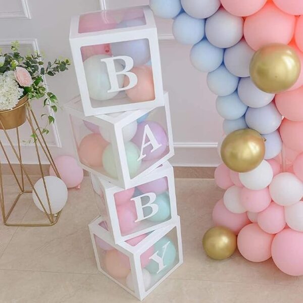Pastel balloon-filled BABY boxes stacked beside a balloon arch for baby shower decoration