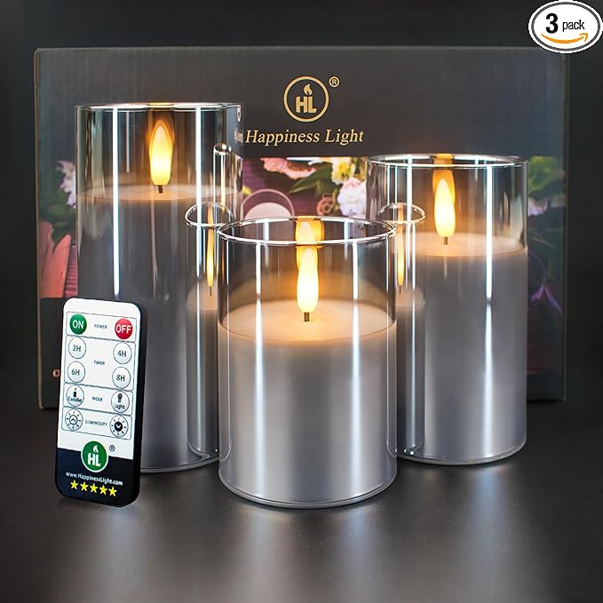 Set of three flameless LED candles with remote control, displayed in clear glass holders – perfect for elegant dining ambiance