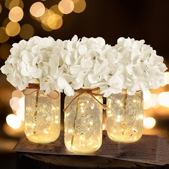Rustic glass vases with jute rope heart accents and artificial white floral arrangements.