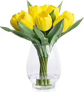 Realistic yellow artificial tulips arranged in a glass vase with faux water for a lifelike floral centerpiece.
