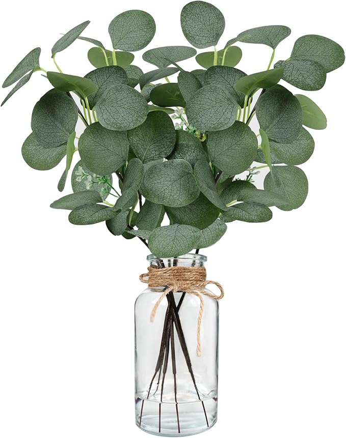 Artificial eucalyptus leaves in a clear glass vase with twine bow accent.