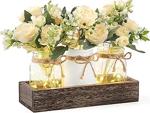 Rustic farmhouse centerpiece with LED-lit mason jars, faux ivory flowers, and wooden tray